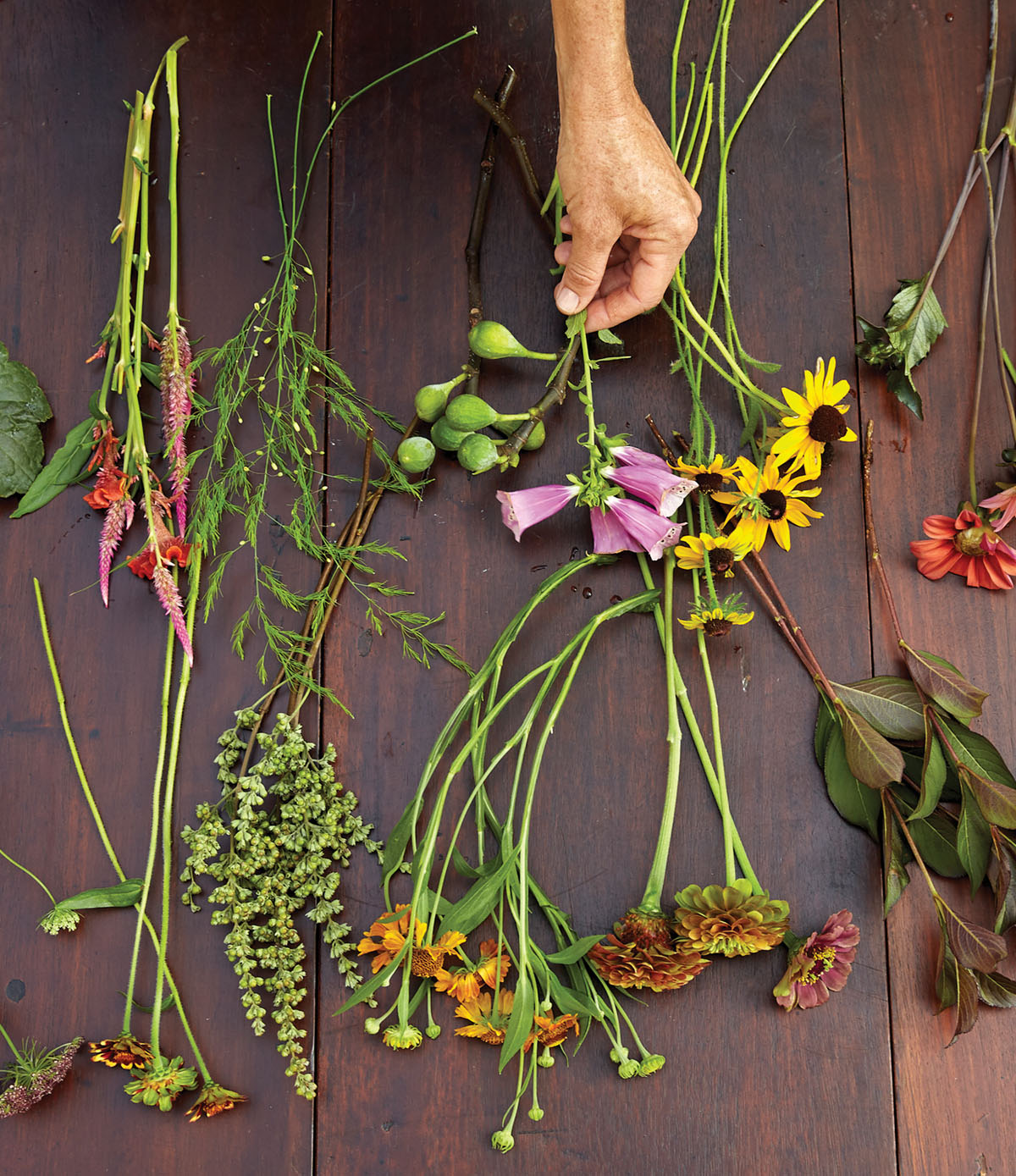 flowers and foliage for Kappi Naftel's floral tutorial laid out on a wooden work surface