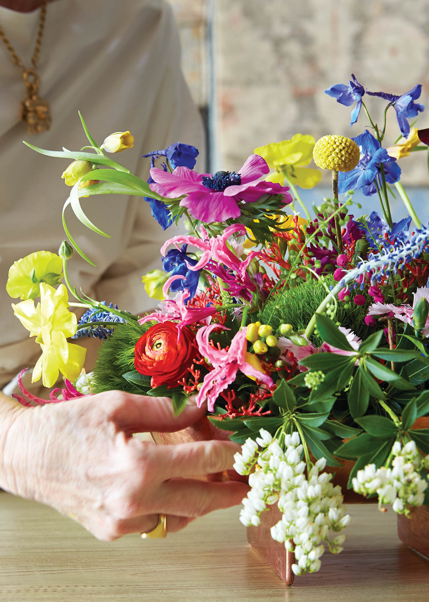 Hands arranging flowers.