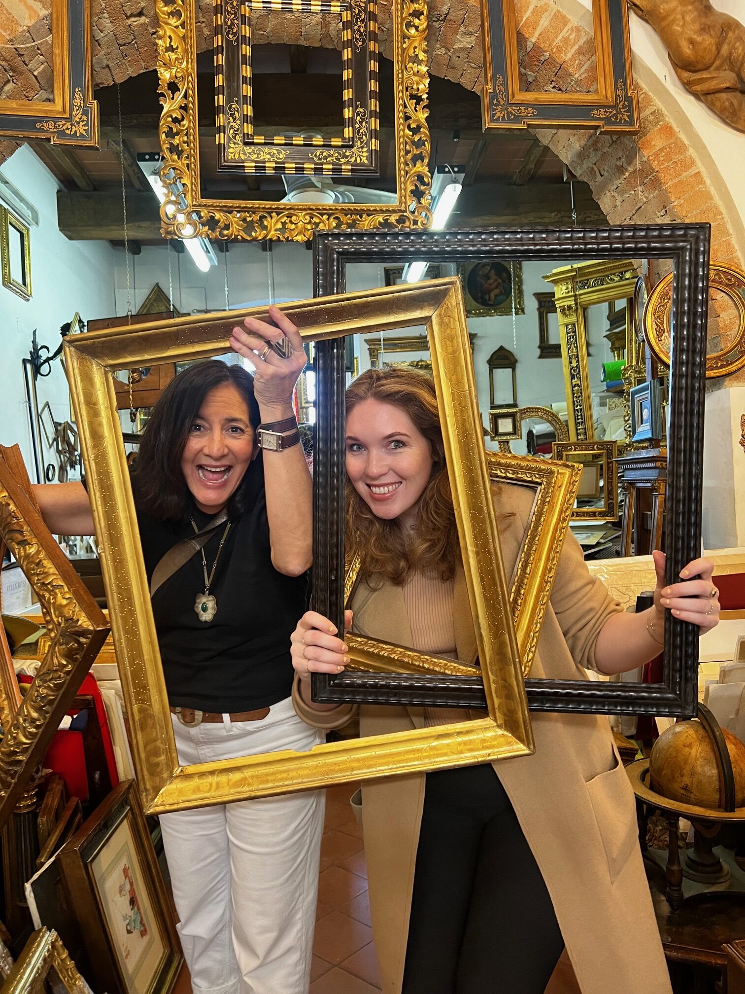 Portrait of Ann Connelly and Chelsea Norris in a frame shop.