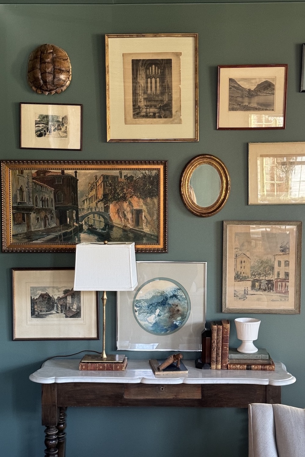 A gallery wall of antique prints in a safe room.